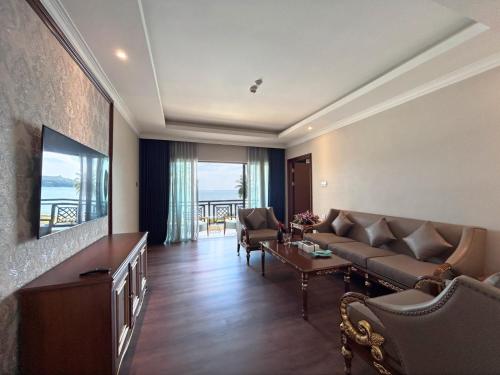 a living room with a couch and a tv at Damai Lagoon Resort in Santubong