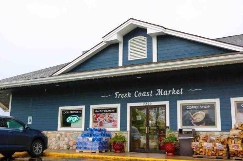a blue building with a first crust market at Dream Palace with HOT TUB-Game Room-Fire Pit-5BR-3BA in Traverse City