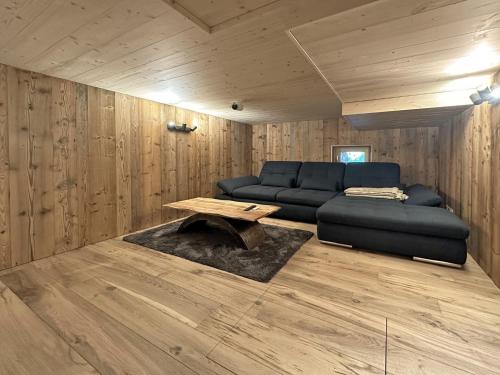 a living room with a couch and a table at Family Chalet Karibu - 4 Vallées - next to Verbier in Bruson