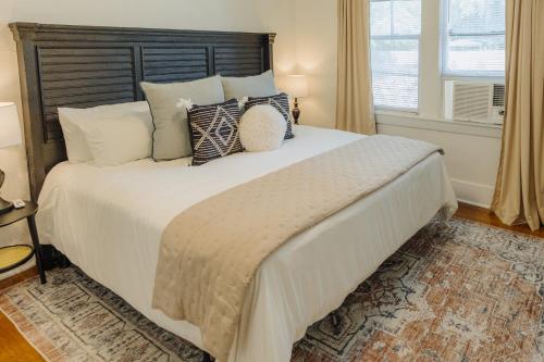 a bedroom with a large bed with pillows and a window at Historic Revival King Bed Midtown Memphis 70 Fast WiFi Free Parking Yes Pets in Memphis