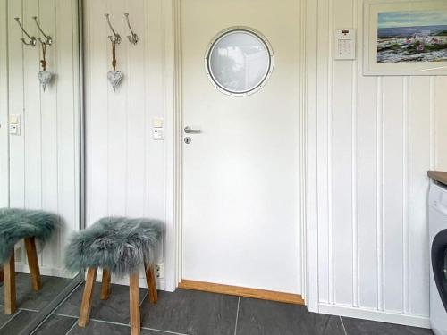 a room with a white door with two chairs with faux fur at 8 person holiday home in averøy-By Traum in Averoy