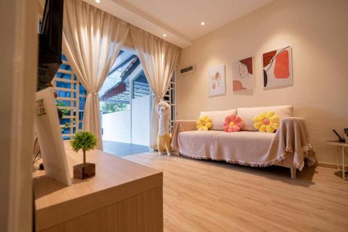 a bedroom with a bed with pillows on it at Ipoh MU House 27- Muji Style/3BR with ATARI GAME in Ipoh