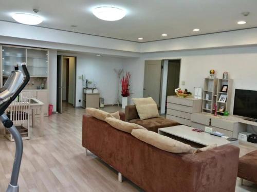 TV a/nebo společenská místnost v ubytování Beijing Jiuxian Apartment
