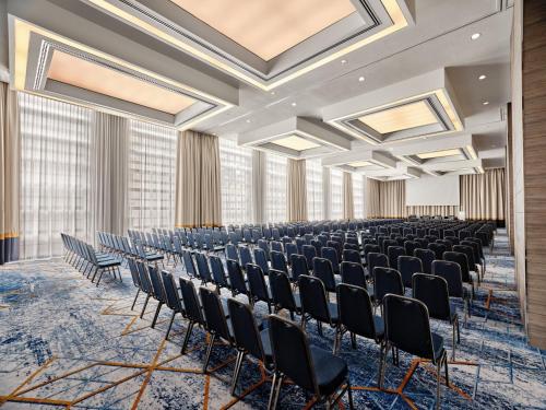 an empty room with rows of chairs and skylights at InterContinental Warszawa by IHG in Warsaw
