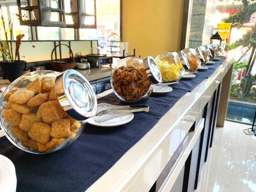 a buffet line with bowls of bread and other food at Walden Hotel in Yilan City