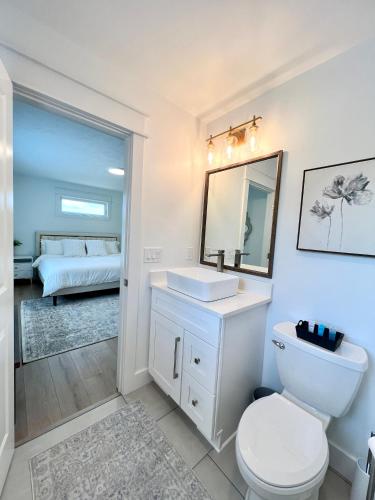a bathroom with a toilet and a sink and a bed at Dream Palace with HOT TUB-Game Room-Fire Pit-5BR-3BA in Traverse City