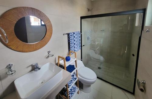 a bathroom with a toilet and a sink and a shower at New Luxury Condo in Mazatlán
