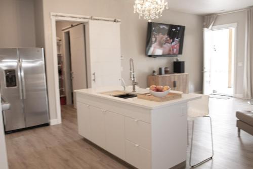 a kitchen with a sink and a refrigerator at Lake Powell Sunrise Villa by Antelope Canyon with firepit and scenic views in Big Water