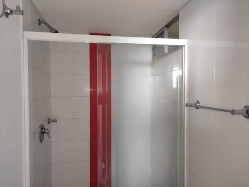 a shower with a glass door in a bathroom at Alex & Kamilo in Bucaramanga