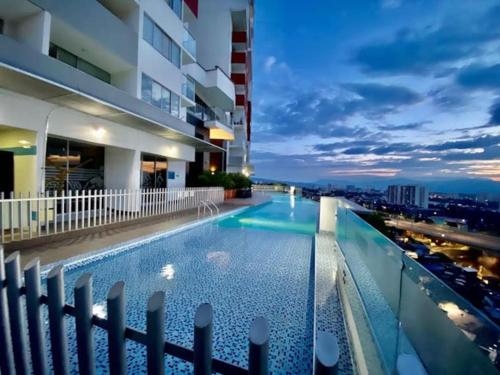 a swimming pool on the roof of a building at night at Alex & Kamilo in Bucaramanga