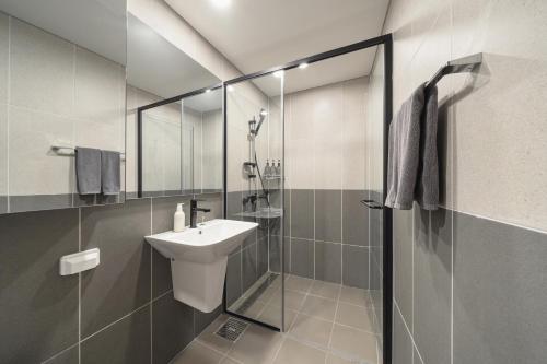 a bathroom with a sink and a glass shower at Le collective Siheung Wavepark in Siheung