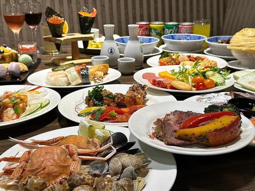 a table with many plates of food on it at Walden Hotel in Yilan City
