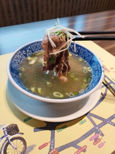 a bowl of soup sitting on a table at Walden Hotel in Yilan City