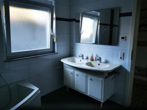 エッテンハイムにあるFerienwohnung Alexのバスルーム(洗面台、鏡、窓付)