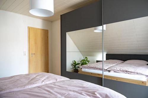 a bedroom with a bed and a mirror at Große Ferienoase mit Burgbergblick (ideal für Familien) in Bevern