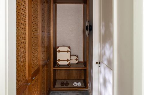 a hallway with a door with a suitcase on a shelf at Four Seasons Resort Dubai at Jumeirah Beach in Dubai