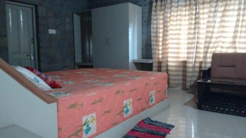 a bedroom with a large pink bed in a room at Vamoose Hampi Homestay Otters Island in Hampi