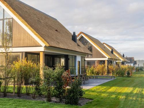 a house with a pitched roof at Luxury villa with sauna only a few minutes from the beach in De Cocksdorp