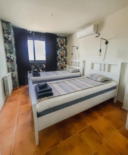 a bedroom with two beds and a window at Casa Altos 39 in La Herradura
