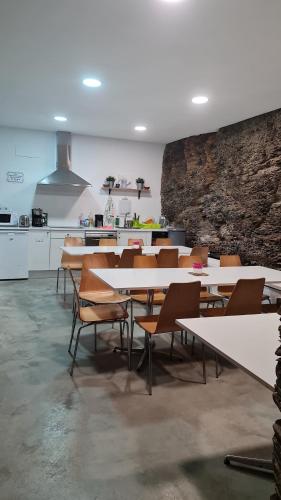 a group of tables and chairs in a room at ALBERGUE CASTELOS in Lorenzana