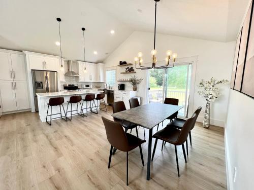 a kitchen and dining room with a table and chairs at Dream Palace with HOT TUB-Game Room-Fire Pit-5BR-3BA in Traverse City