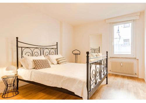 a bedroom with a black bed and a window at Residenza Cristoforo in Udine