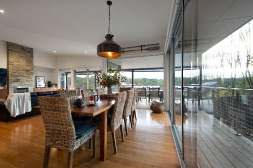 a dining room with a wooden table and chairs at Bilsons Landing East in Daylesford