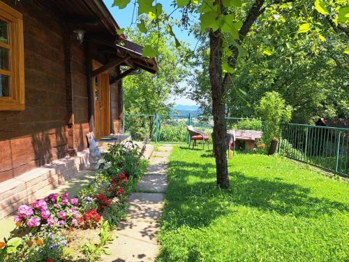 a garden with flowers next to a house at Kokotova hiža in Gornja Konjšćina