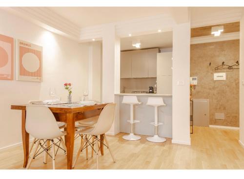 a kitchen and dining room with a table and chairs at Residenza Cristoforo in Udine