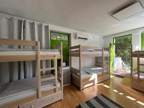 a room with three bunk beds in it at Hostel Scardona in Skradin