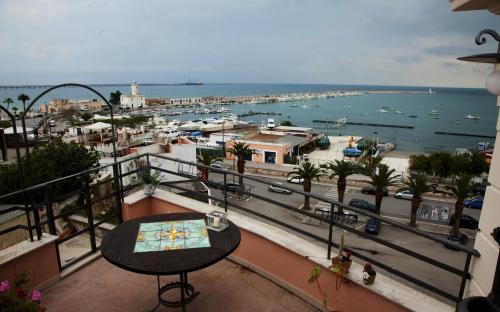 a balcony with a table and a view of a harbor at La Dolce Vista - B&B di Charme in Manfredonia