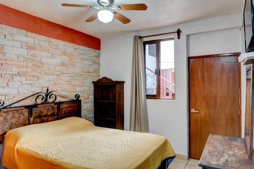 a bedroom with a bed and a ceiling fan at Hotel Spa Casa del Sol in Guanajuato