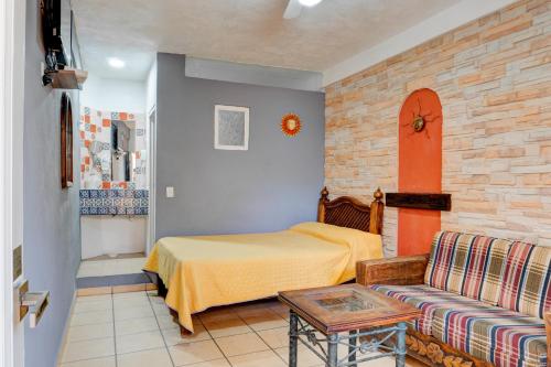 a bedroom with a bed and a couch at Hotel Spa Casa del Sol in Guanajuato