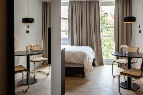 a hotel room with a bed and a window at HApato in Munich