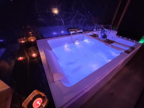 a bath tub with lights in a dark room at Caen, Tu m'aimes - Suite Romantique in Caen