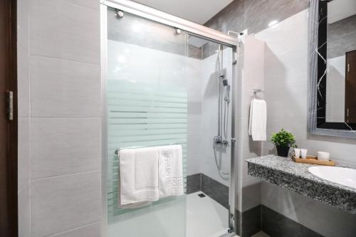 a bathroom with a shower and a sink at The Suites @ Bellavista in Isabel