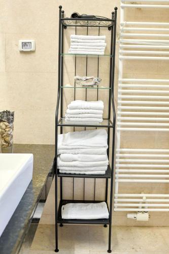 a towel rack with towels on it in a bathroom at Apartament Caelia Mamaia DANA in Mamaia