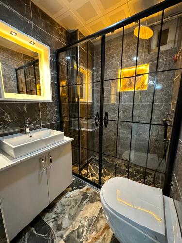 a bathroom with a shower and a toilet and a sink at Fevkalade & Aparts Otel in Kemer