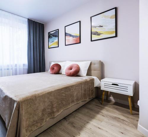 a bedroom with a bed with two pillows on it at Апартаменти MYFREEDOM поруч із метро Харківська in Kyiv