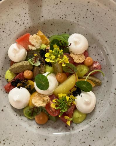 a plate of food with vegetables on a table at B&B Herenhuis in Izegem