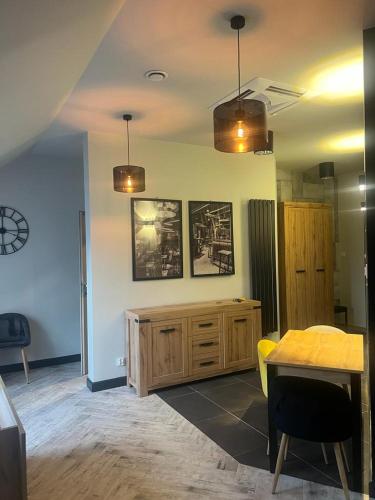 a living room with a table and a dining room at Apartamenty Terminal Charzykowy in Charzykowy