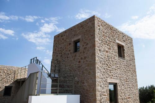 a brick building with a staircase on the side of it at Riverstone Villas with private pools in Levktron