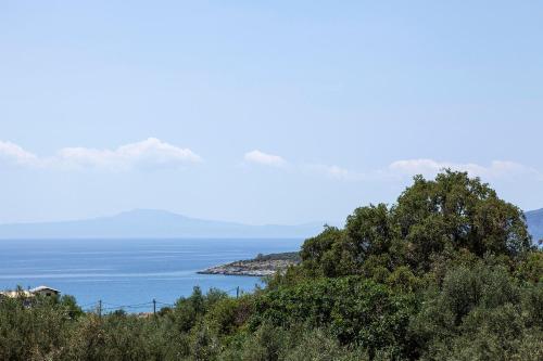 a view of the ocean from a hill with trees at Riverstone Villas with private pools in Levktron