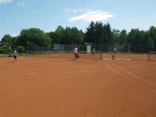 a group of people playing tennis on a tennis court at Ferienhaus Freilingen in Blankenheim