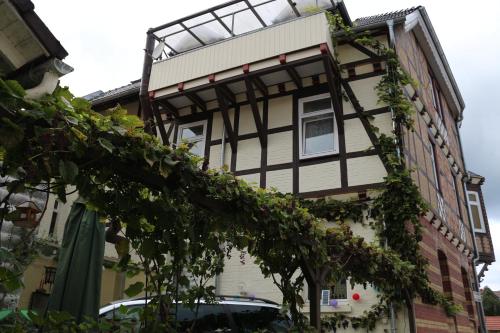 a house with a gambrel roof with ivy growing on it at Hotel Alte Post in Bad Sooden-Allendorf