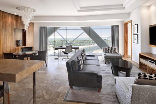 a living room with a couch and a table at Andaz Capital Gate Abu Dhabi, By Hyatt in Abu Dhabi