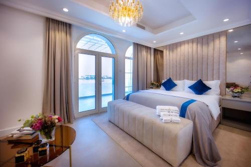 a bedroom with a bed and a couch and a window at Villa Mallorca - Exclusive 11-Bedroom Villa with signature Amenities By Luxury Explorers Collection in Dubai