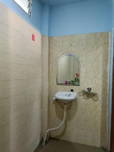 a bathroom with a sink and a mirror at Hotel Blue Coral Rameswaram in Rāmeswaram