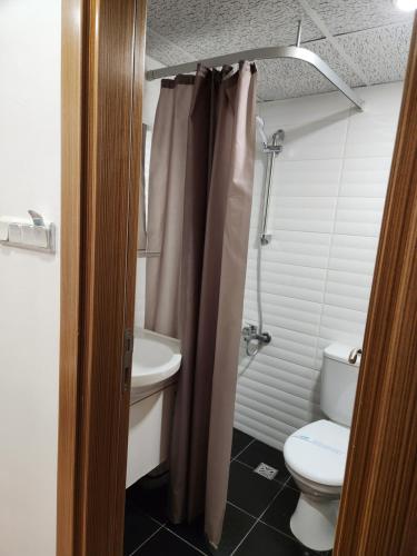 a bathroom with a toilet and a sink at Esperanza Hotel in Antalya