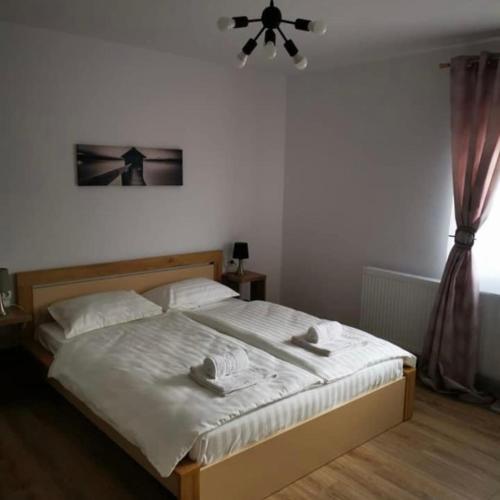 een slaapkamer met een bed met twee handdoeken erop bij Zen in Tălmaciu